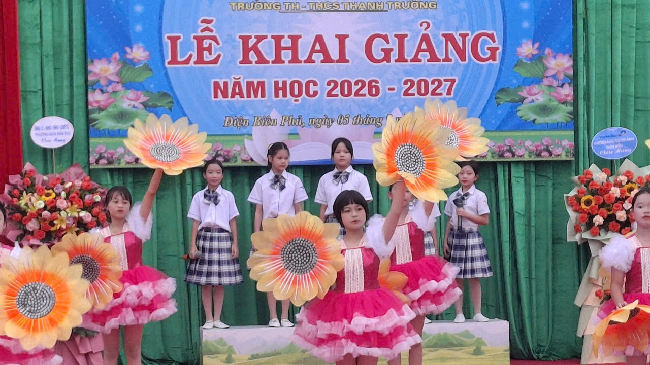 'A group of children on a stage

Description automatically generated'