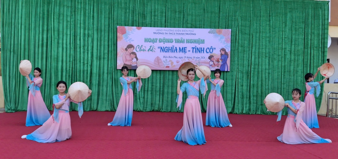 'A group of women in dresses on a stage
Description automatically generated'