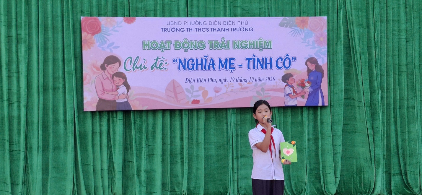 'A person standing in front of a banner
Description automatically generated'